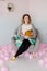 Young woman sitting on chair and holding merino wool in hands