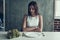 Young Woman Sitting on Chair with Salad on Table.