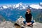 Young woman sitting on cliff and enjoy the view