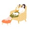 Young woman sitting in comfy yellow chair with footrest, using smartphone. Stay home concept. Girl with a white cat
