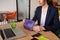 Young woman sitting at the desk opening lunch box