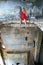 Young woman sitting on the edge in abandoned const