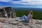 Young woman sitting at the edge of roc at Minnewaska State Park