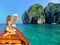 Young woman sitting at the front of longtail boat in Maya Bay on