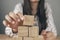 young woman sitting in front of a pyramid of cubes