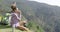 Young woman sitting ground and drinking