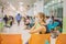 Young woman sitting in hospital waiting for a doctor`s appointment. Patients In Doctors Waiting Room