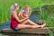 Young woman sitting with mirror at natural water