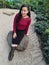 young woman sitting in a park posing