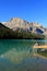 Young woman sitting on a pier at Emerald Lake, Yoho National Par