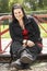 Young Woman Sitting In Playground