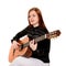 young woman sitting poses in the studio holding a classical guit