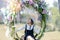 Young woman sitting on rattan hanging chair