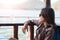 Young woman sitting seat on boat while drinking water viewing sc