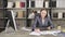 young woman sitting, smile, happy working on financial graph and tablet, looks smart in workplace