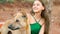 young woman sitting with a stray dog and both looking in the same direction