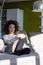 Young woman sitting in the sun on indoor lounge