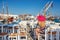 Young woman sitting at a traditional tavern in Naousa of Paros, Greece