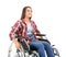 Young woman sitting in wheelchair on white background