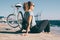 Young woman sitting on wooden embankment