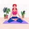Young woman sitting in yoga posture and meditating indoor with lots of plants. Girl doing morning meditation at home. Physical and