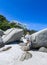 A young woman sittingon the boulders of clifton beach in the capetown area of south africa.3