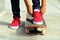 Young woman skateboarder tying shoelace