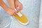 Young woman skateboarder tying shoelace