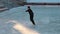 Young woman skates on a frozen lake