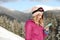 Young woman with ski goggles using smartphone in mountains during vacation