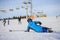 Young woman skier after the fall on mountain slope