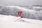 Young woman skier skiing fast downhill on ski slope