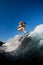 Young woman skillfully jumping on a wave on a wakesurf board