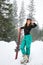 Young woman with skis wearing winter sport clothes