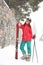 Young woman with skis wearing winter sport clothes