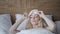 Young woman sleep on comfortable bed in a mask for sleeping. Blindfold on eye. Morning in hotel room. White pillow and