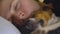 Young woman sleeping, her small Jack Russell terrier near - closeup detail on their heads