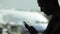 Young woman with smart phone at the airport with airplane on the background