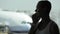 Young woman with smart phone at the airport with airplane on the background