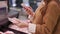 Young woman with a smartphone in her hand scans a package of meat in a supermarket.