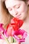 Young woman smelling flowers