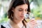 Young woman smelling white wine at tasting.