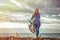 A young woman with a smile on her face cleans the beach of debris. Keeping the environment clean. With love for nature concept