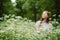 Young Woman smiling arms raised up, enjoy nature, celebrating freedom on green. Positive emotions. Daily Affirmations