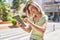 Young woman smiling confident using touchpad at park