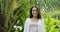 Young woman smiling outdoors happy brunette girl closeup over green trees in tropical forest