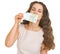 Young woman sniffing 100 euros banknote