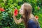 Young woman sniffing hibiscus in the park