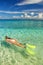 Young woman snorkeling in clear shallow water