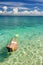 Young woman snorkeling in clear shallow water